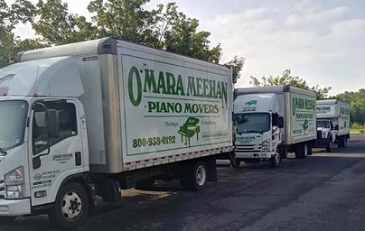O'Mara Meehan Piano Moving Trucks in a liine